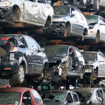 Scrap cars stacked at a yard