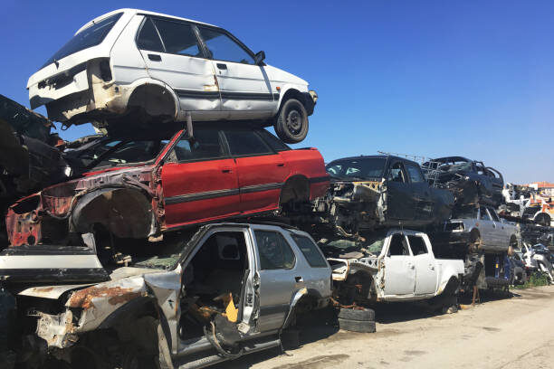 Scrapped cars stacked in a recycling yard for vehicle scrapping in Hyderabad by VSCRAPIT.