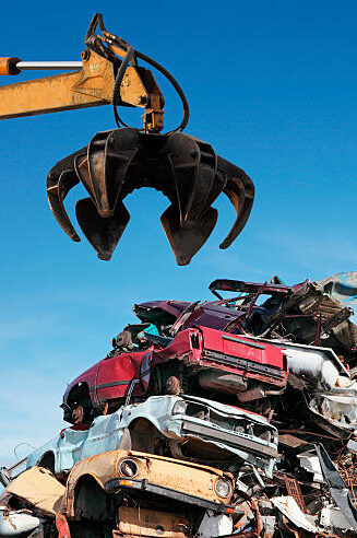 Crane claw grabbing metal scrap