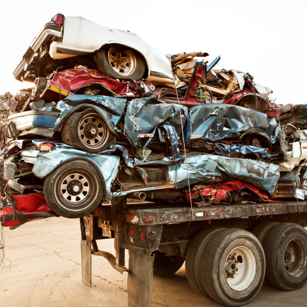 Truck carrying crushed cars