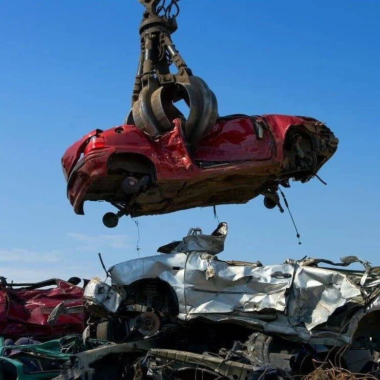 Crane lifting a damaged car for scrapping