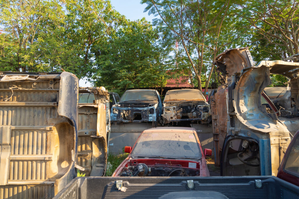 Old damaged cars kept in a scrapyard for vehicle recycling in Mumbai handled by VSCRAPIT.