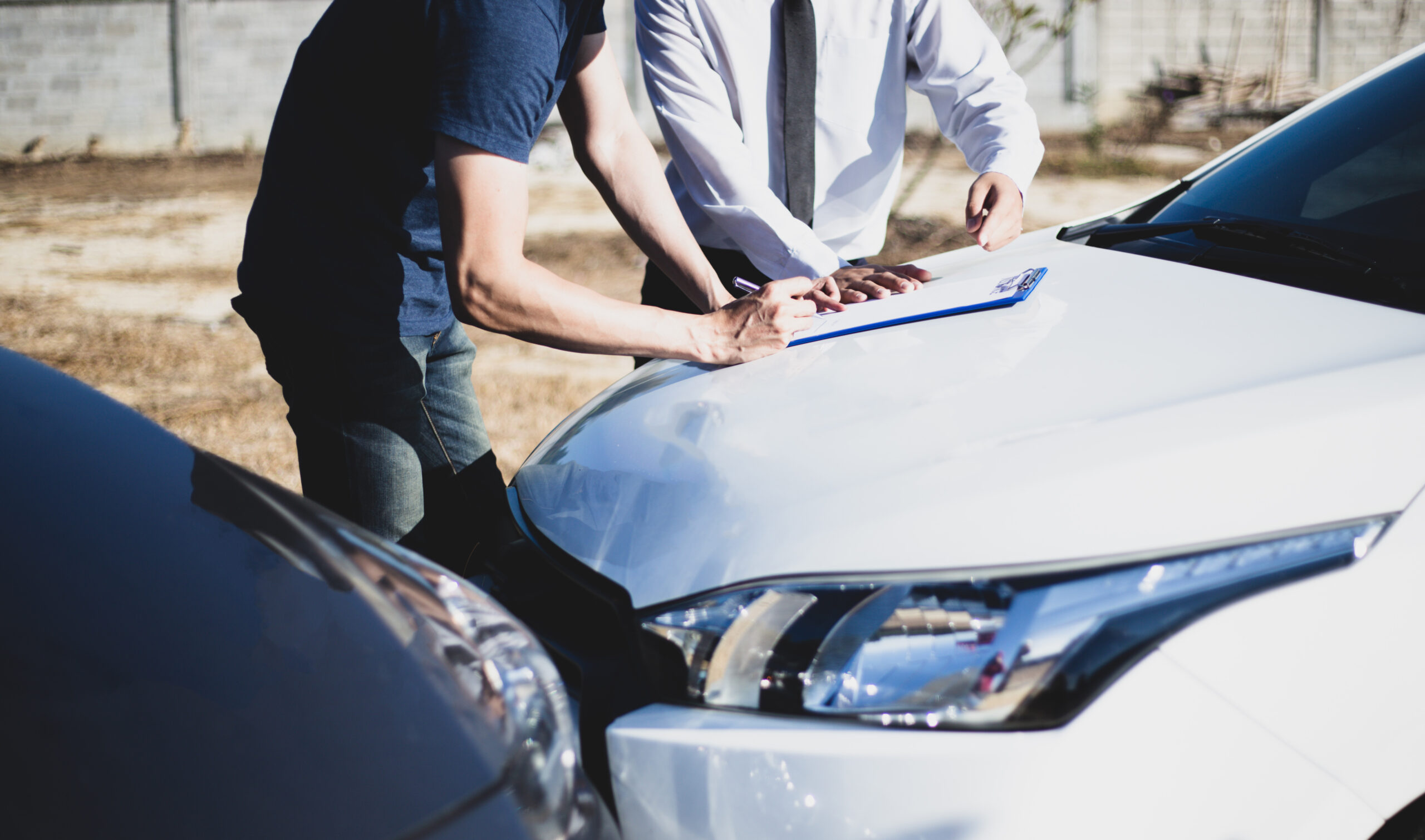Customers and car insurance agents have entered into agreements and signed documents to claim compensation after a car crash, Insurance concept.