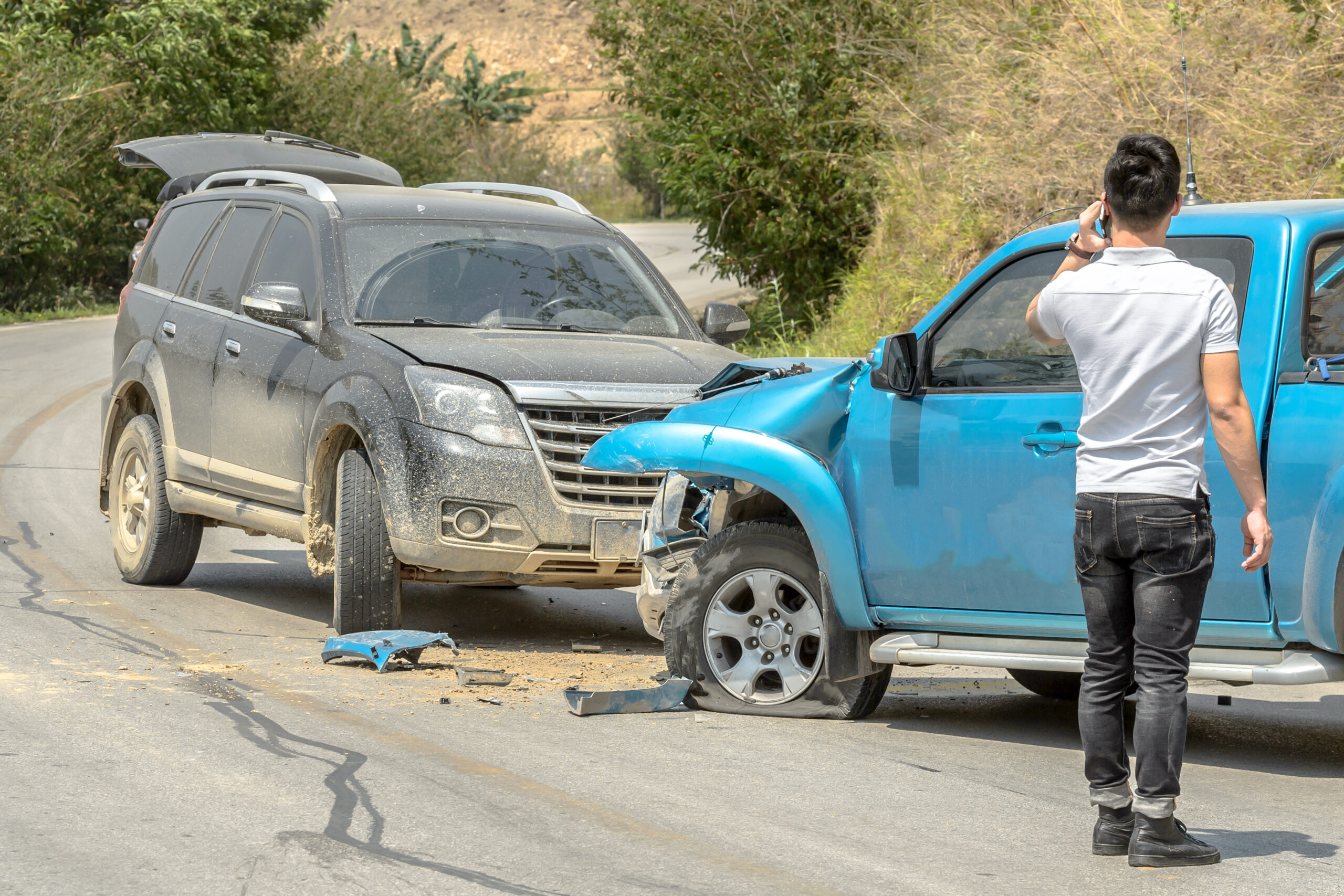 Car crash from car accident on the rural road between saloon versus pickup wait insurance.