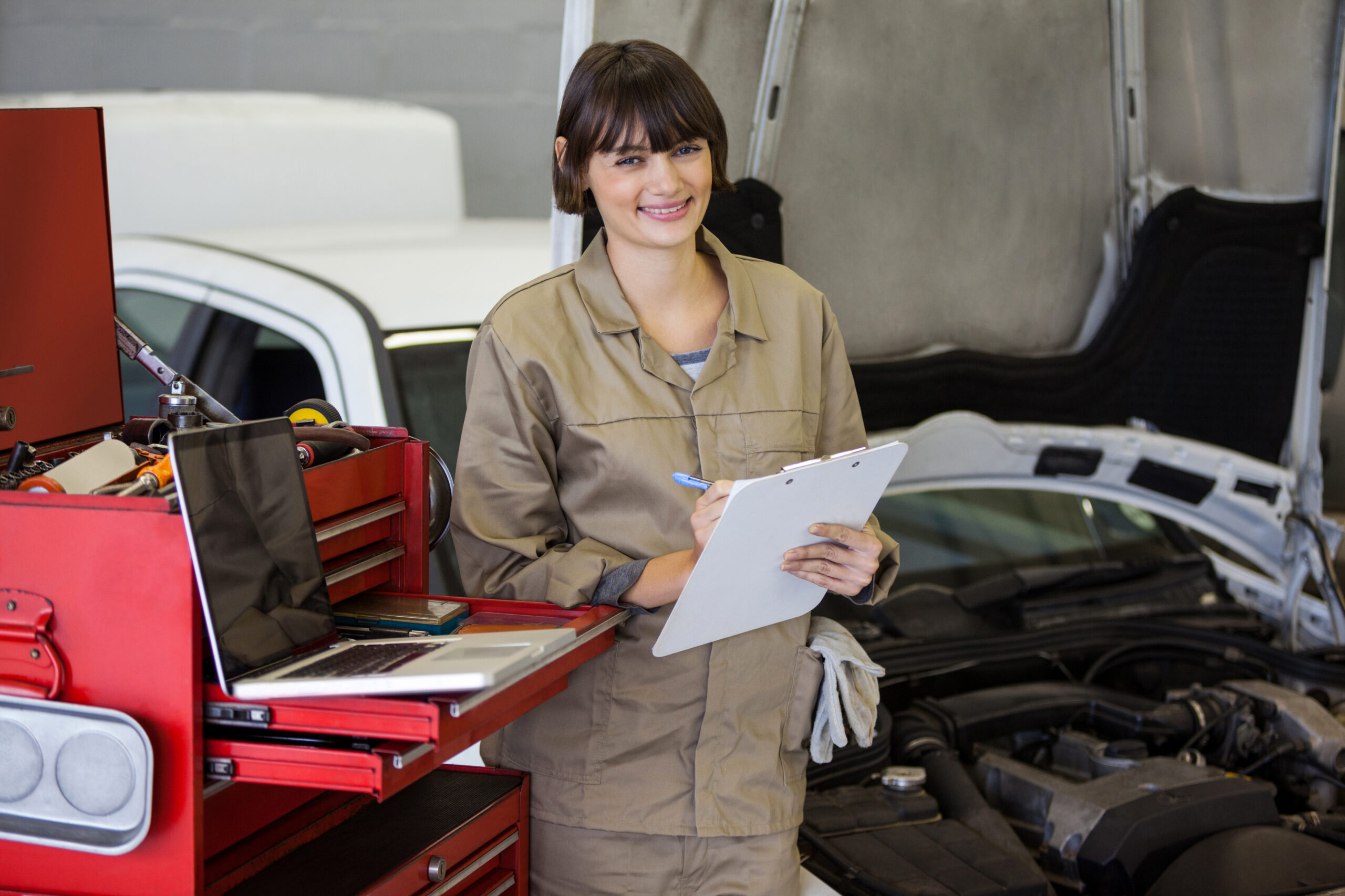 Female mechanic preparing a check list at the repair garage